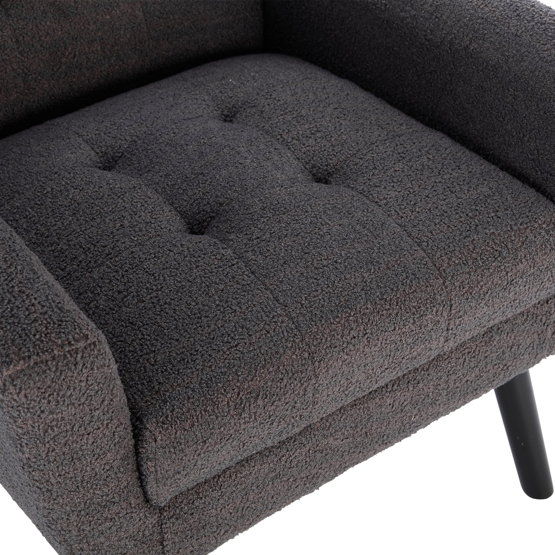 Tufted dark grey boucle armchair seat with black legs