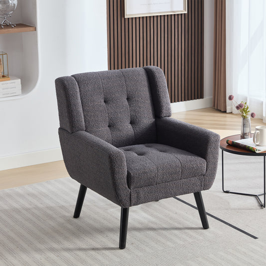 Textured dark gray boucle armchair with tufted back and seat on black legs