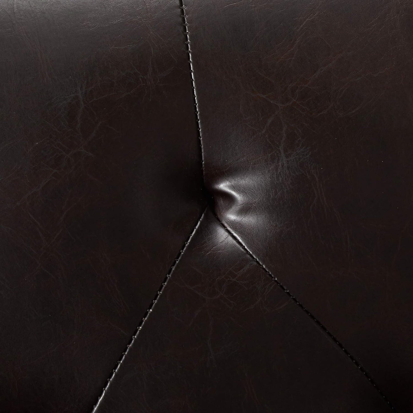Dark brown faux leather texture with stitching detail on tufted accent pillow