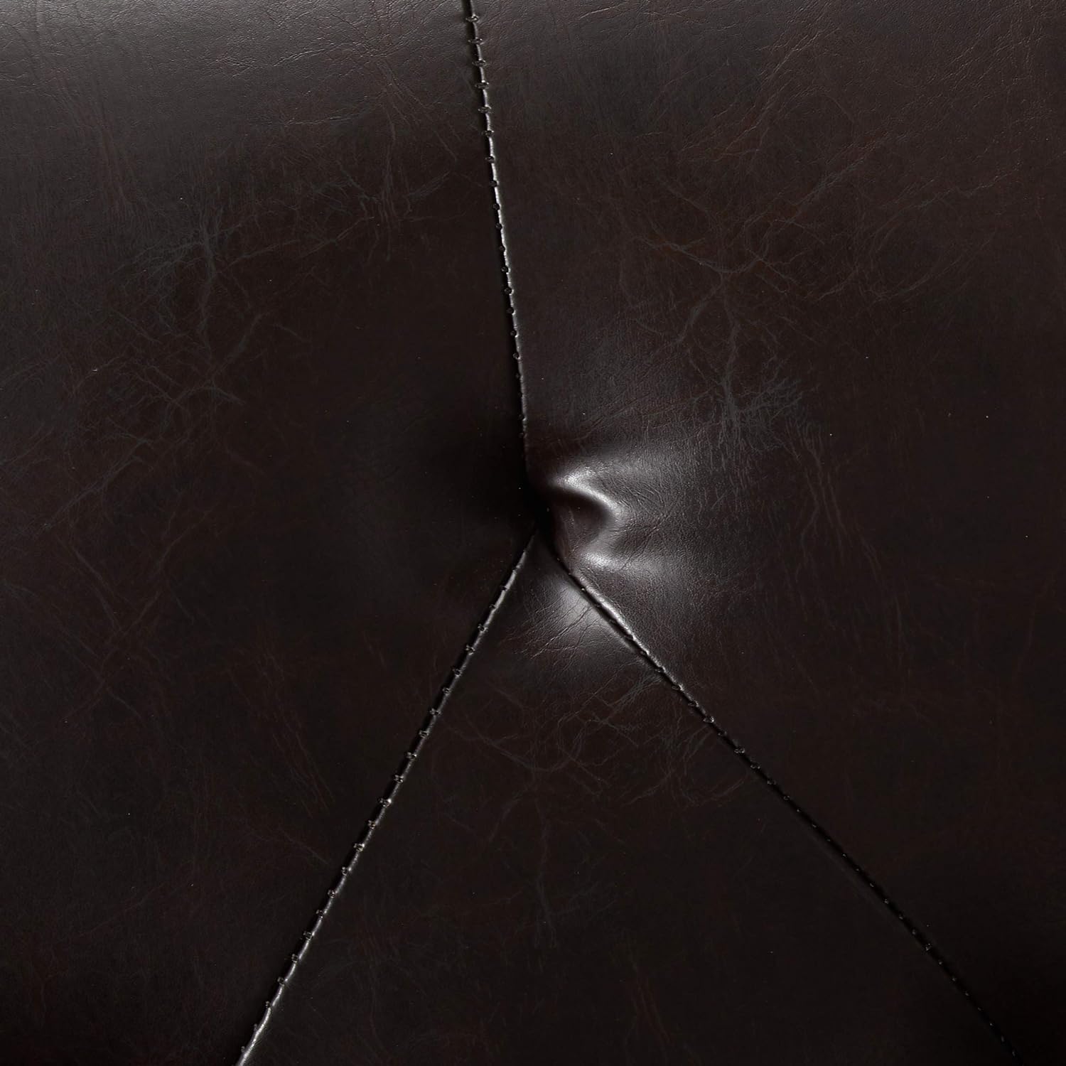 Dark brown faux leather texture with stitching detail on tufted accent pillow