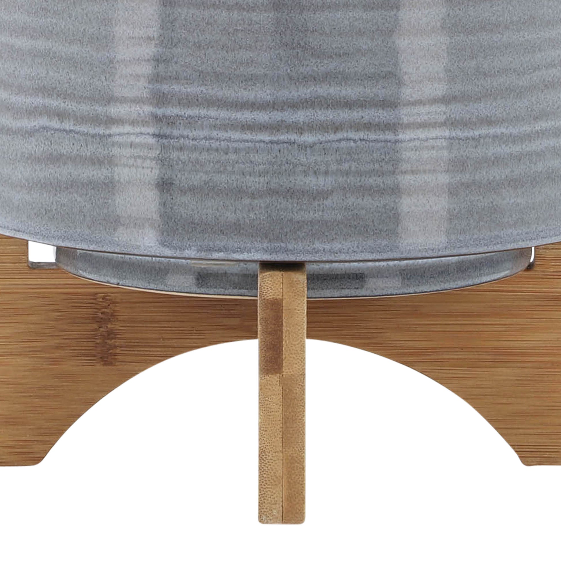 Gray ceramic planter with a textured finish on a bamboo stand