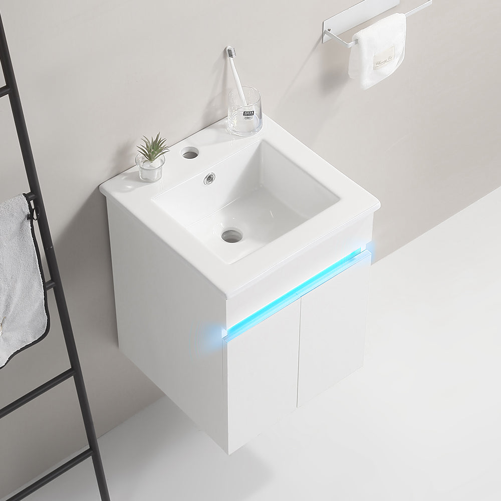 Modern white wallmounted vanity with integrated sink and blue LED accent lighting