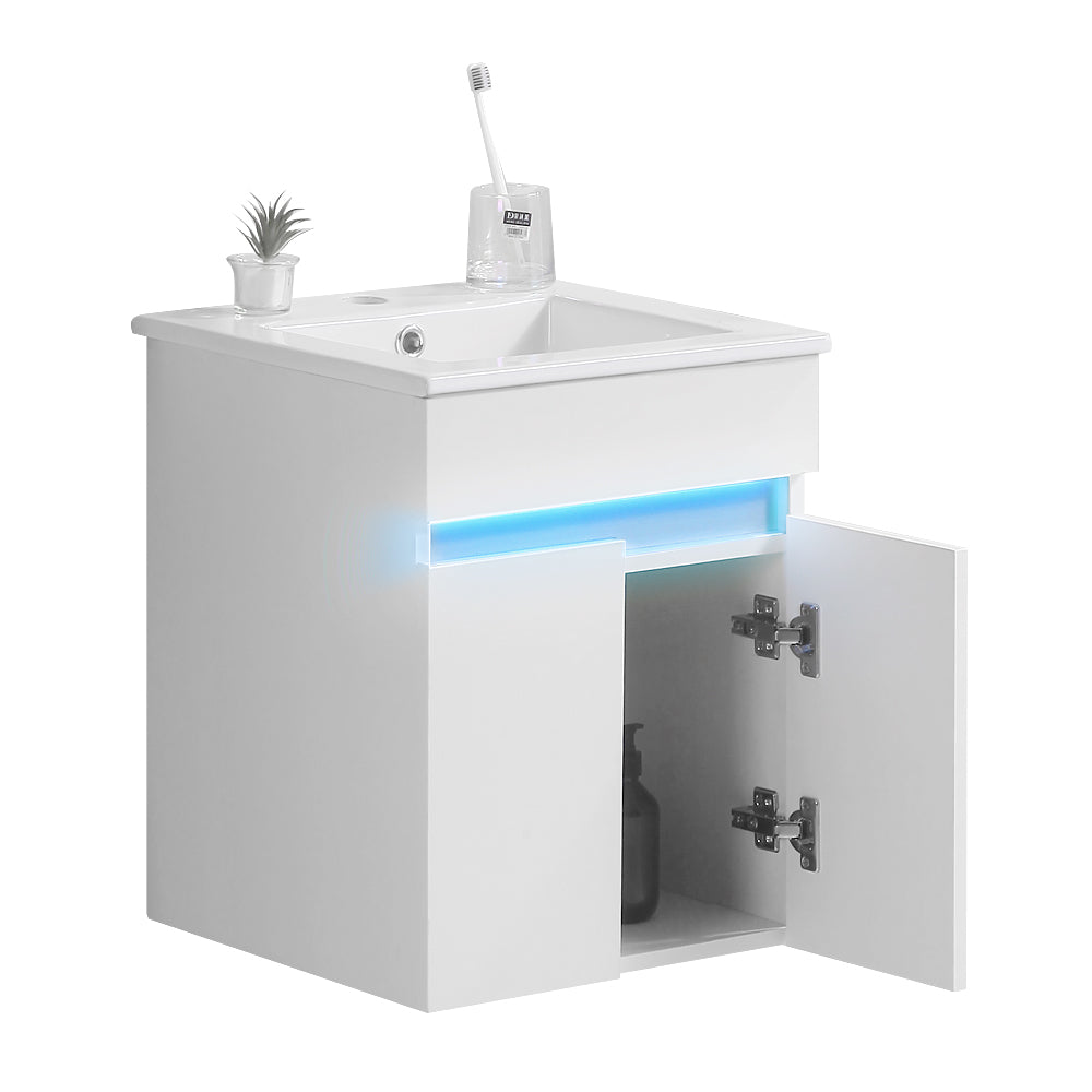 White modern corner vanity unit with integrated LED lighting and open cabinet
