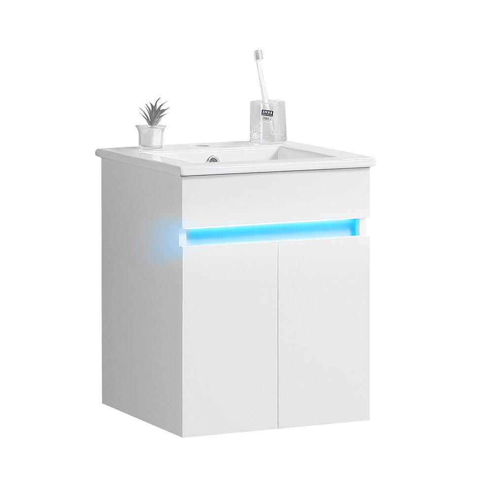 Modern white vanity with blue LED accent lighting and integrated sink