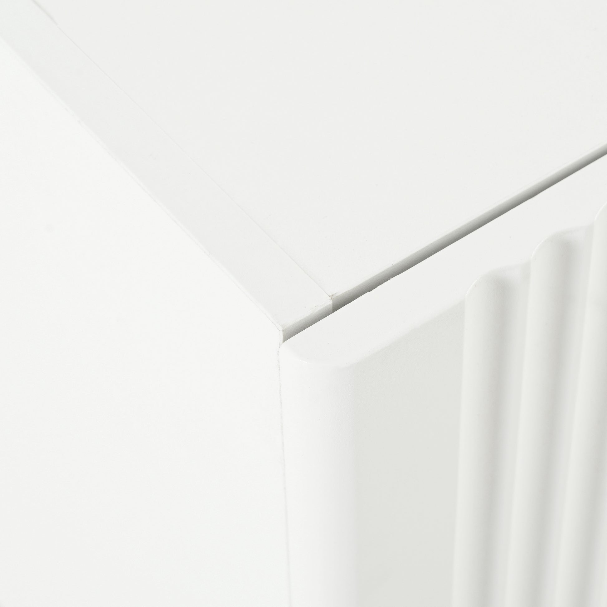 Closeup of a white cabinet with fluted detailing on its side panel