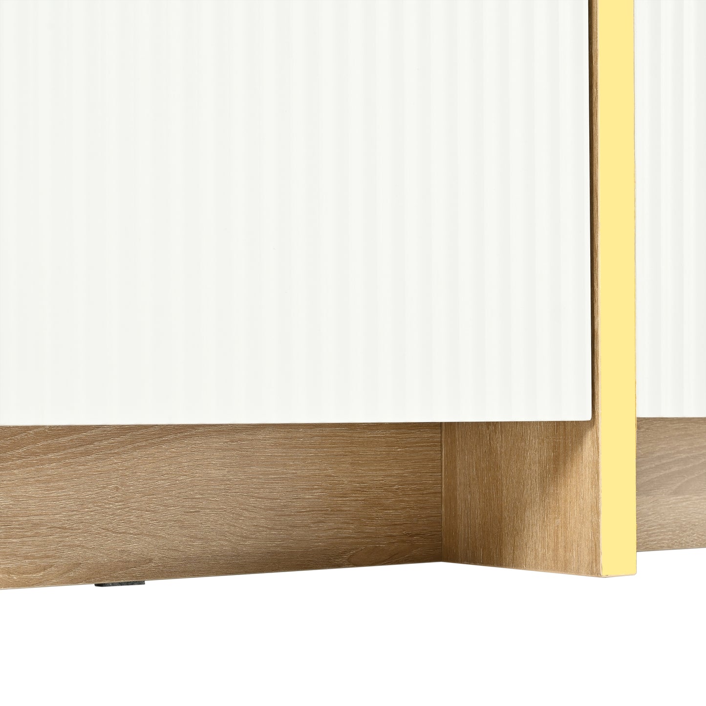 Closeup of white fluted cabinet doors with oak wood base and gold trim accent