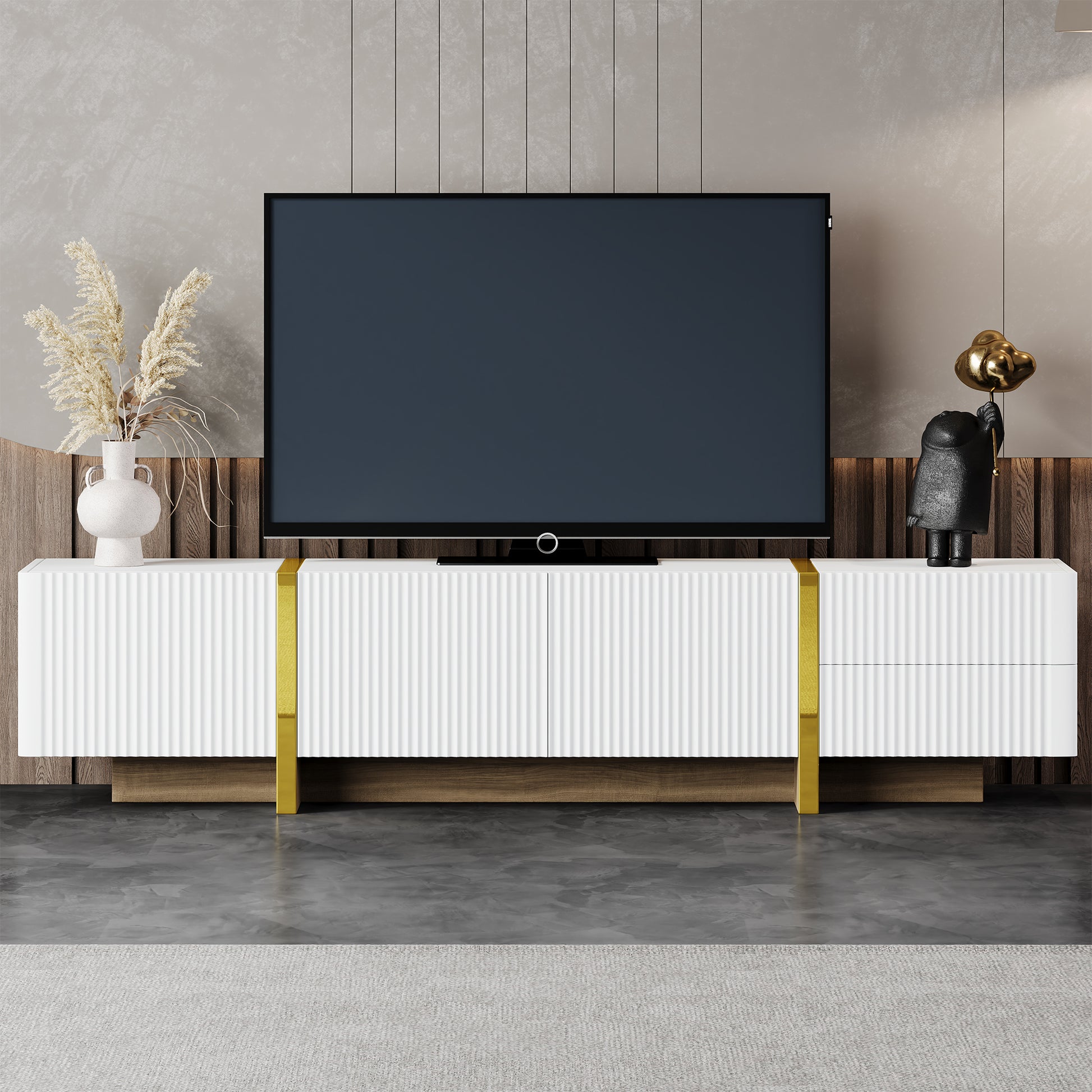 White fluted media console with gold accents and a large TV screen
