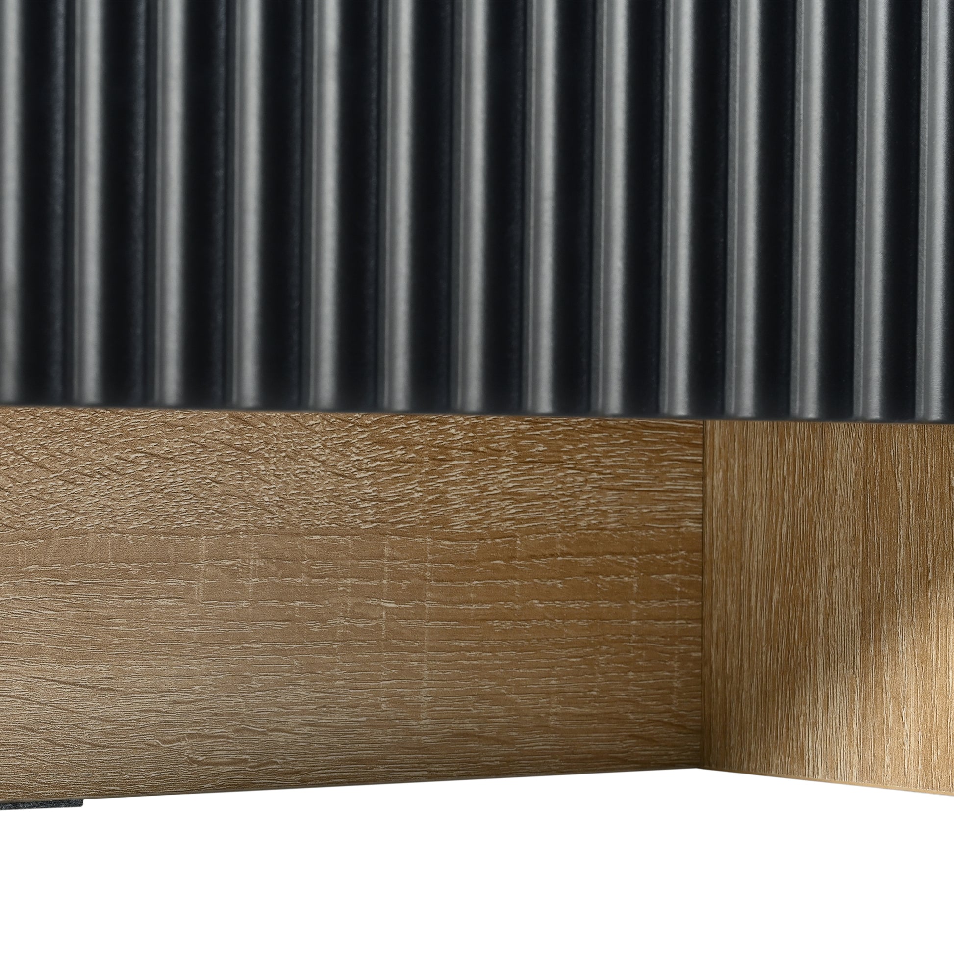 Textured black ribbed panel above a natural wood grain surface