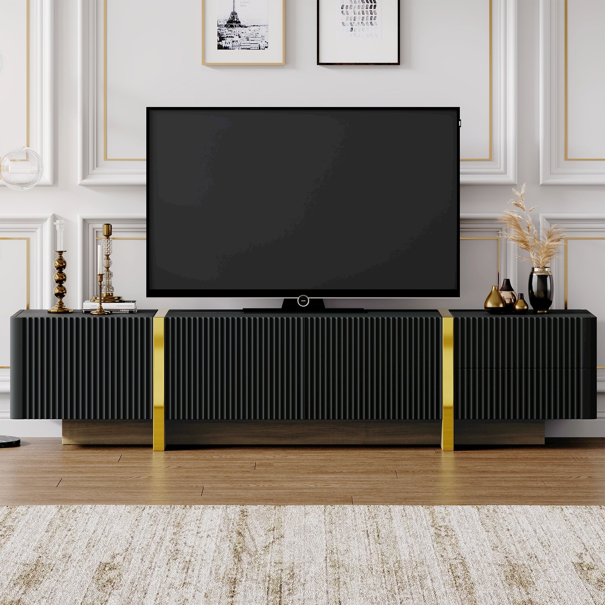 Black fluted media console with gold accents designed to hold a large TV