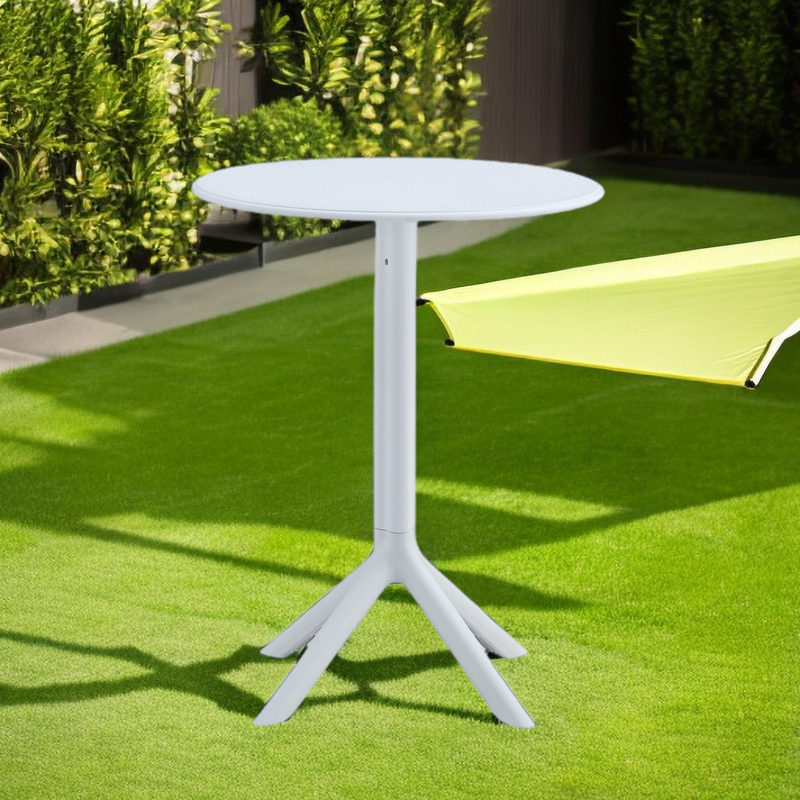 White round outdoor bistro table with a textured top and a fourlegged base on artificial grass