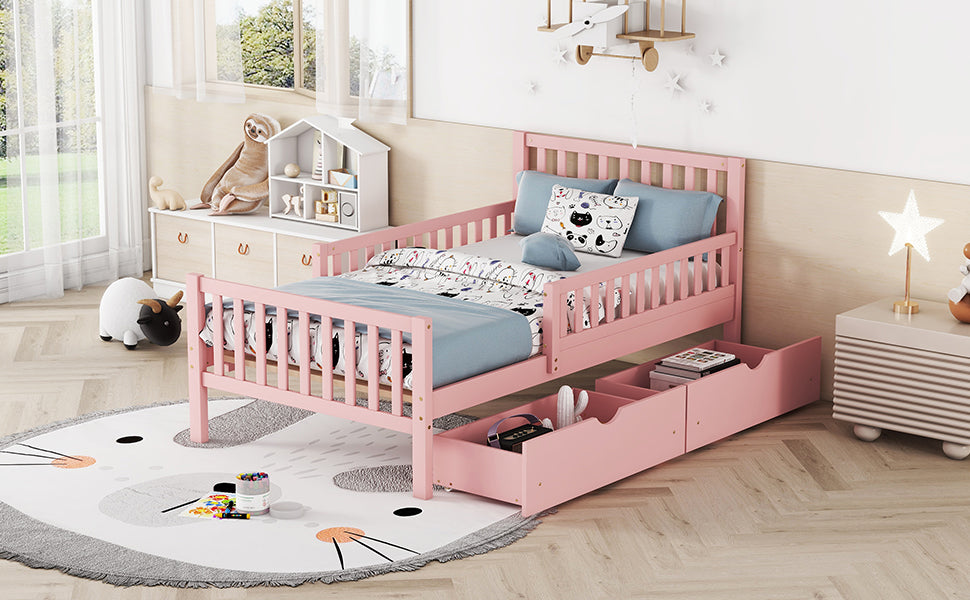 Pink wooden toddler bed with safety rails and two storage drawers