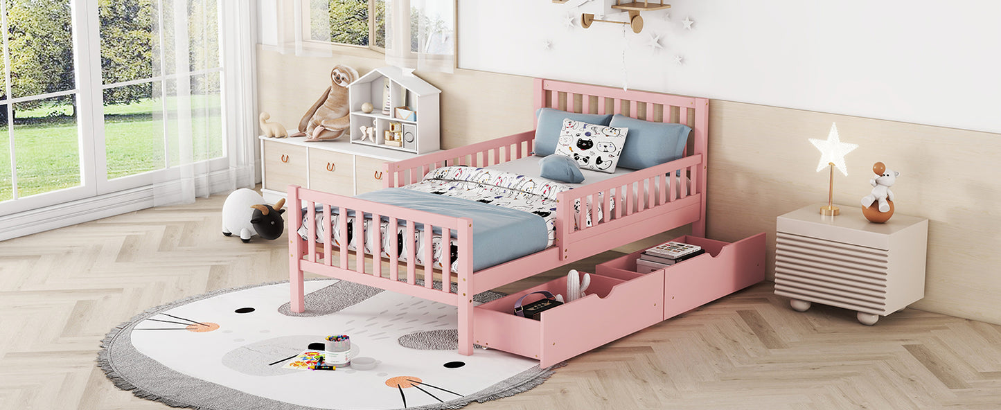 Pink wooden toddler bed with guardrails and storage drawers