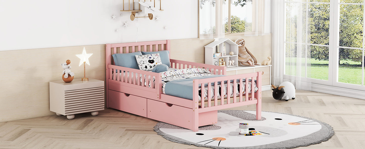 Pink toddler bed with slatted sides and storage drawers perfect for kids rooms