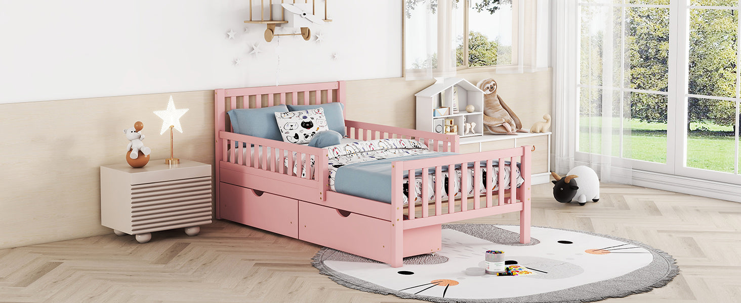 Pink toddler bed with slatted sides and storage drawers perfect for kids rooms