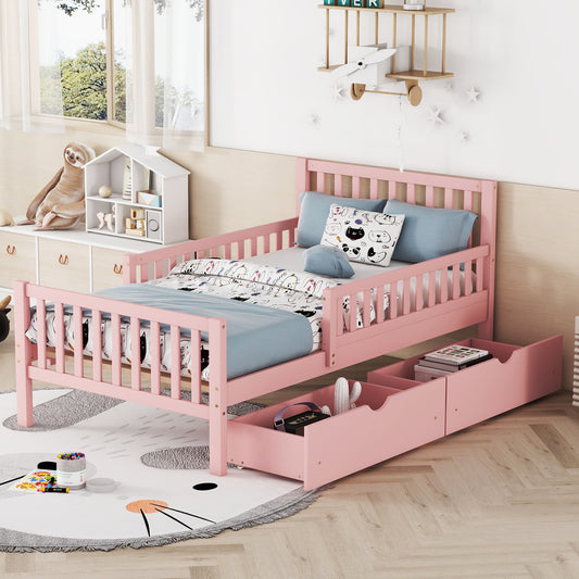 Pink wooden toddler bed with drawers and playful bedding