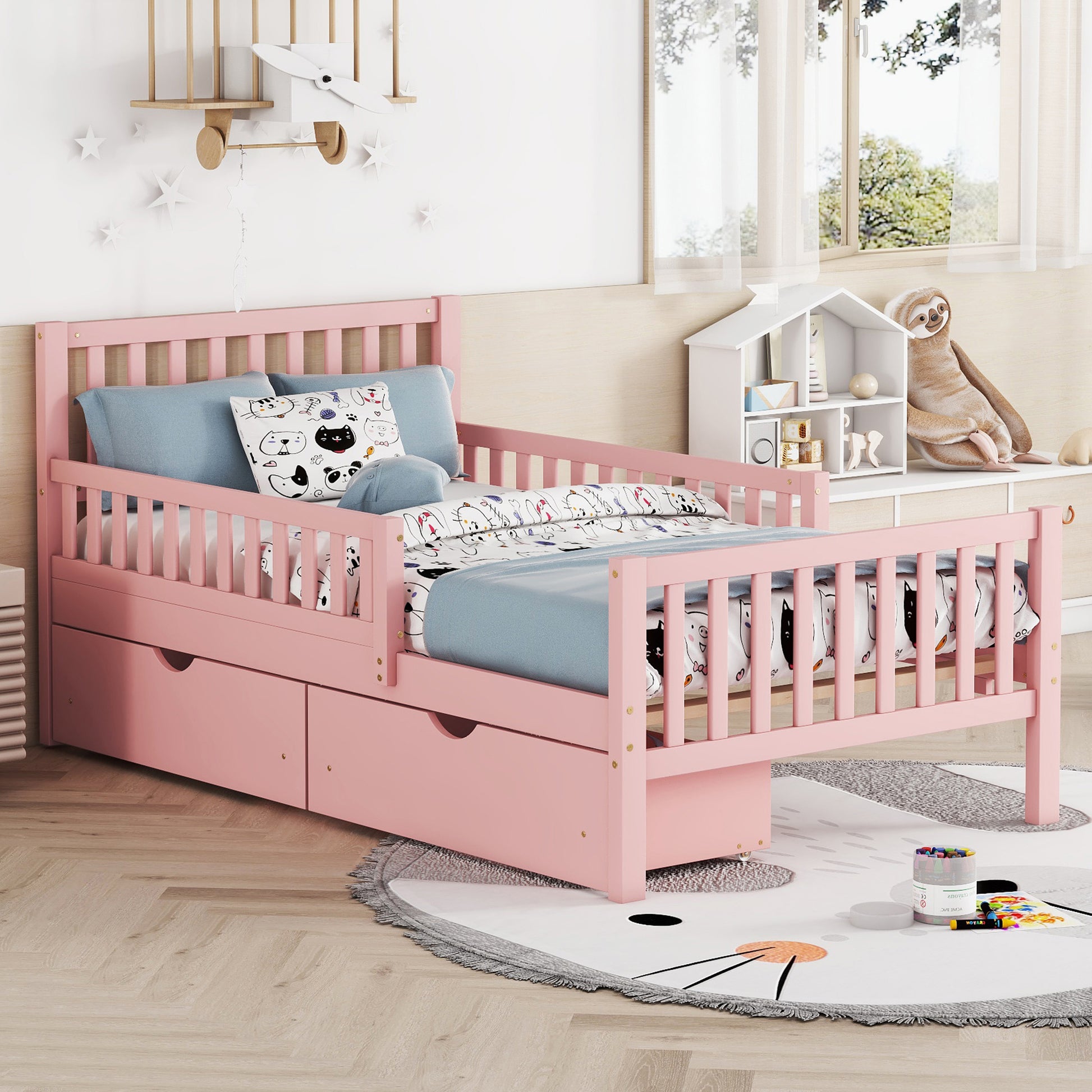 Pink toddler bed with guardrail and storage drawers