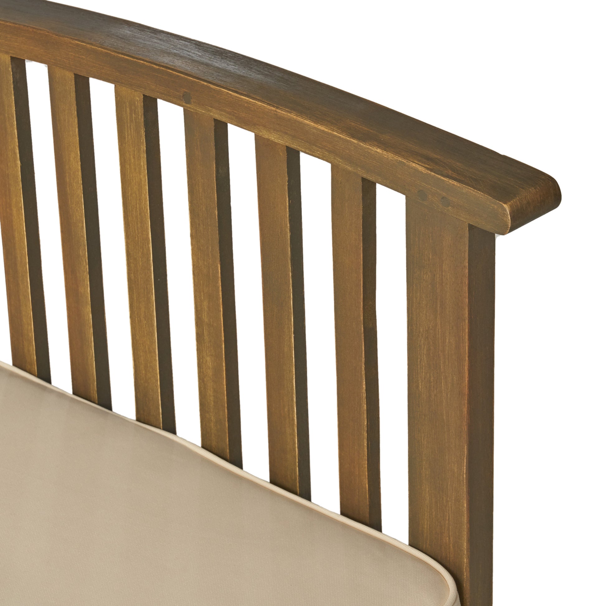 Detail of a wooden slat back dining chair with a beige cushion