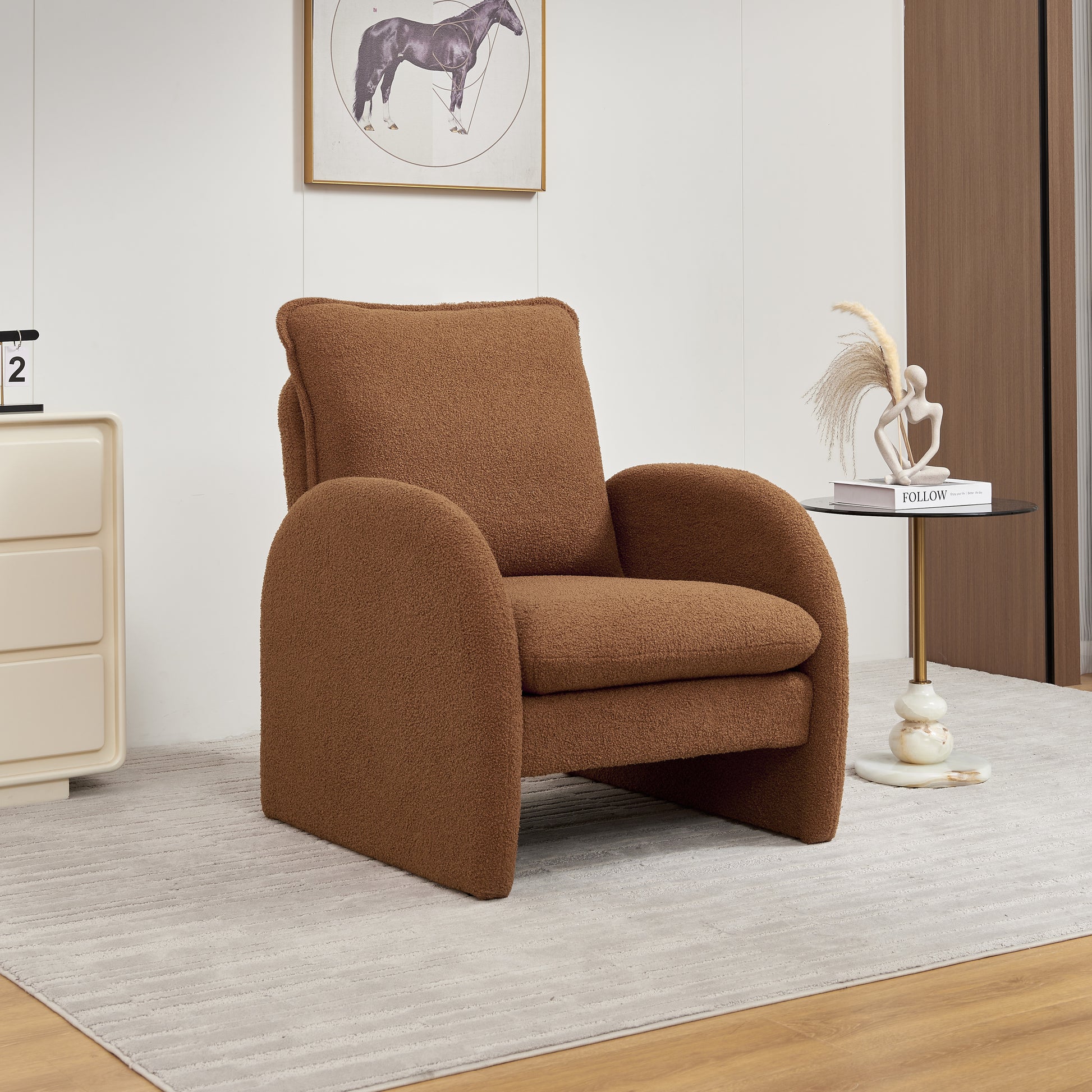 Plush brown boucle accent chair with curved arms and a plush seat cushion for a cozy reading nook