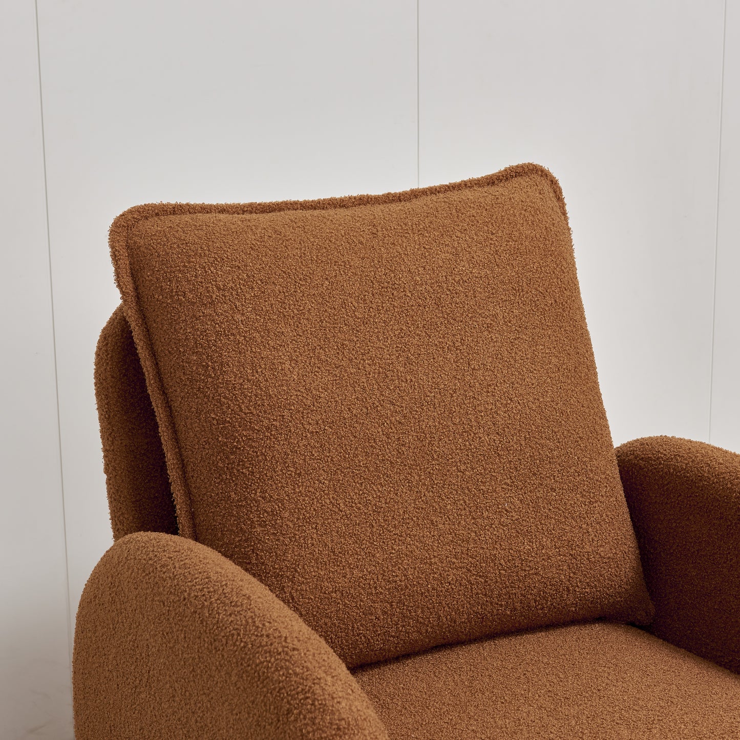 Brown boucle armchair with plush textured fabric and a comfortable lumbar pillow