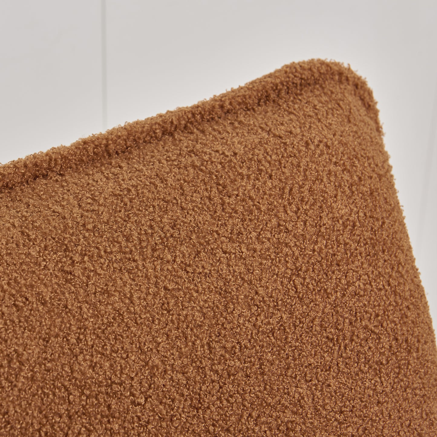 Closeup of a rich caramel teddy bear fleece throw with a plush curly texture