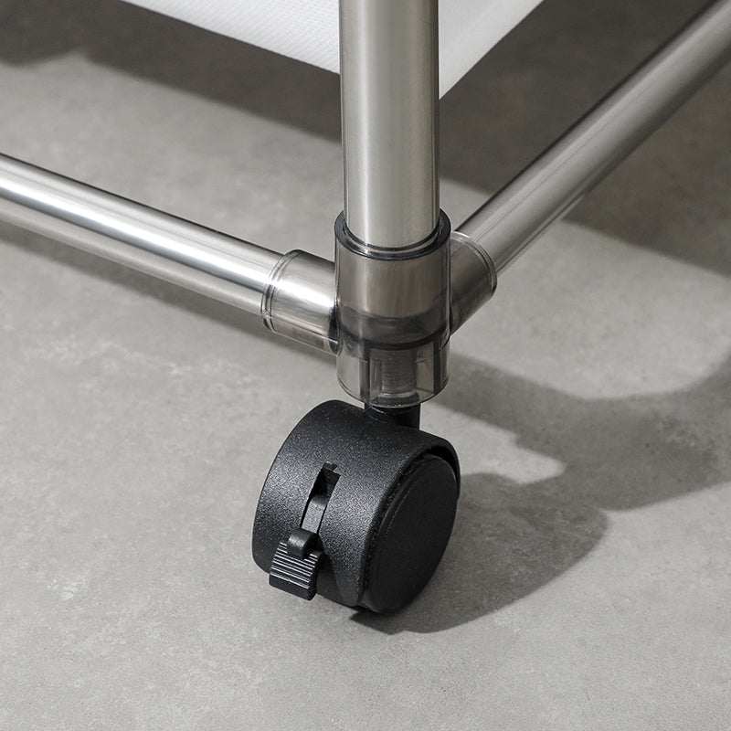 Closeup of a black rolling caster wheel on a metal storage cart