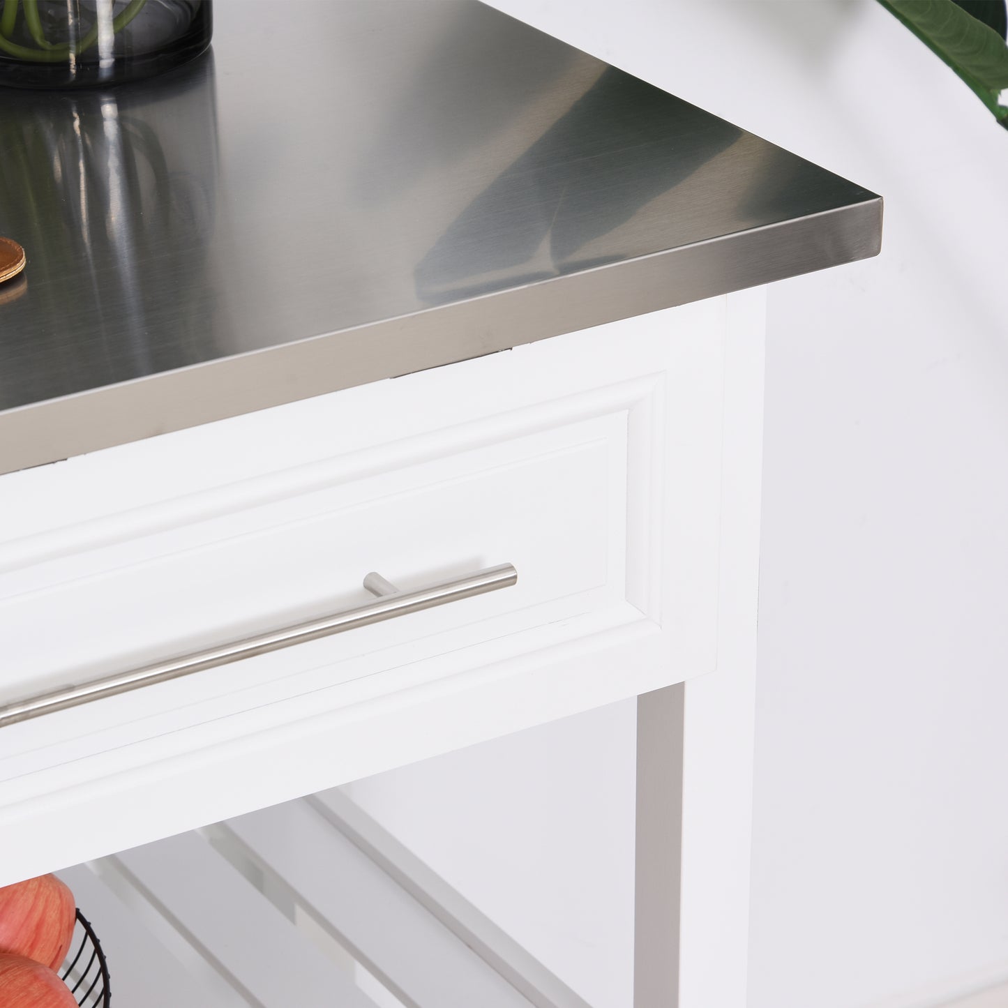 White kitchen cart with stainless steel countertop and silver drawer pull