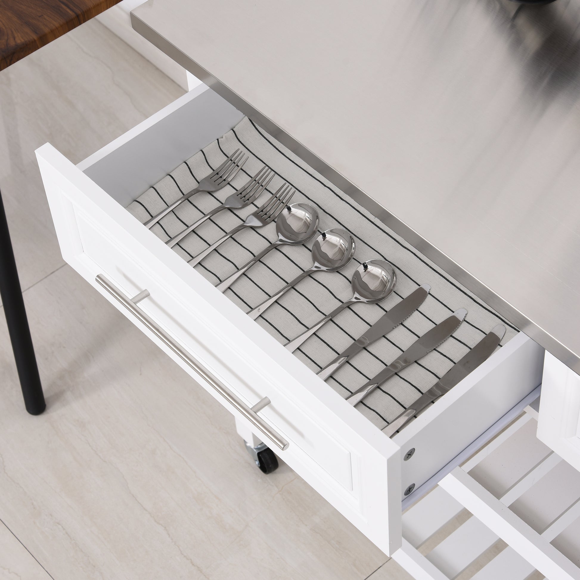 Stainless steel ladle and soup spoons neatly arranged in a drawer