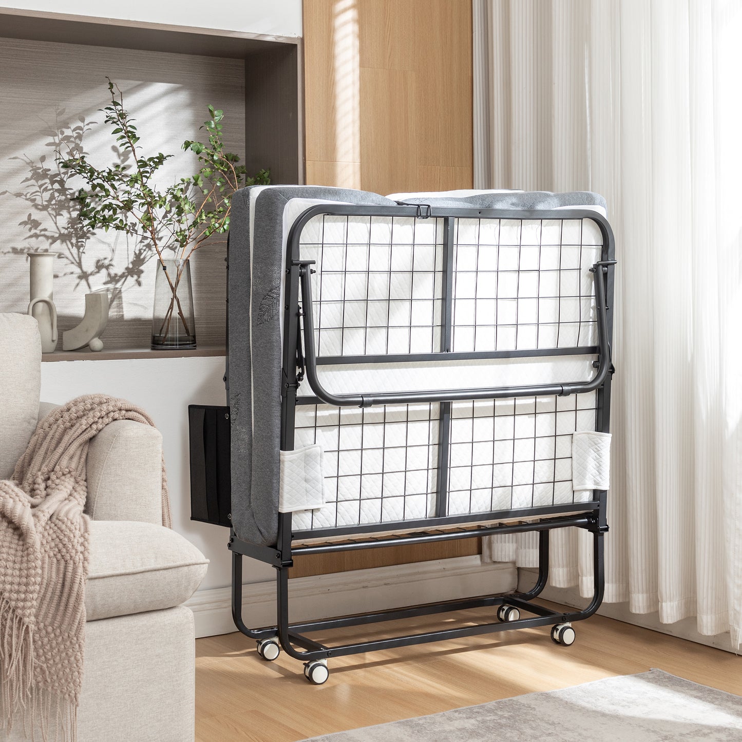 Gray folding bed with metal frame and wheels