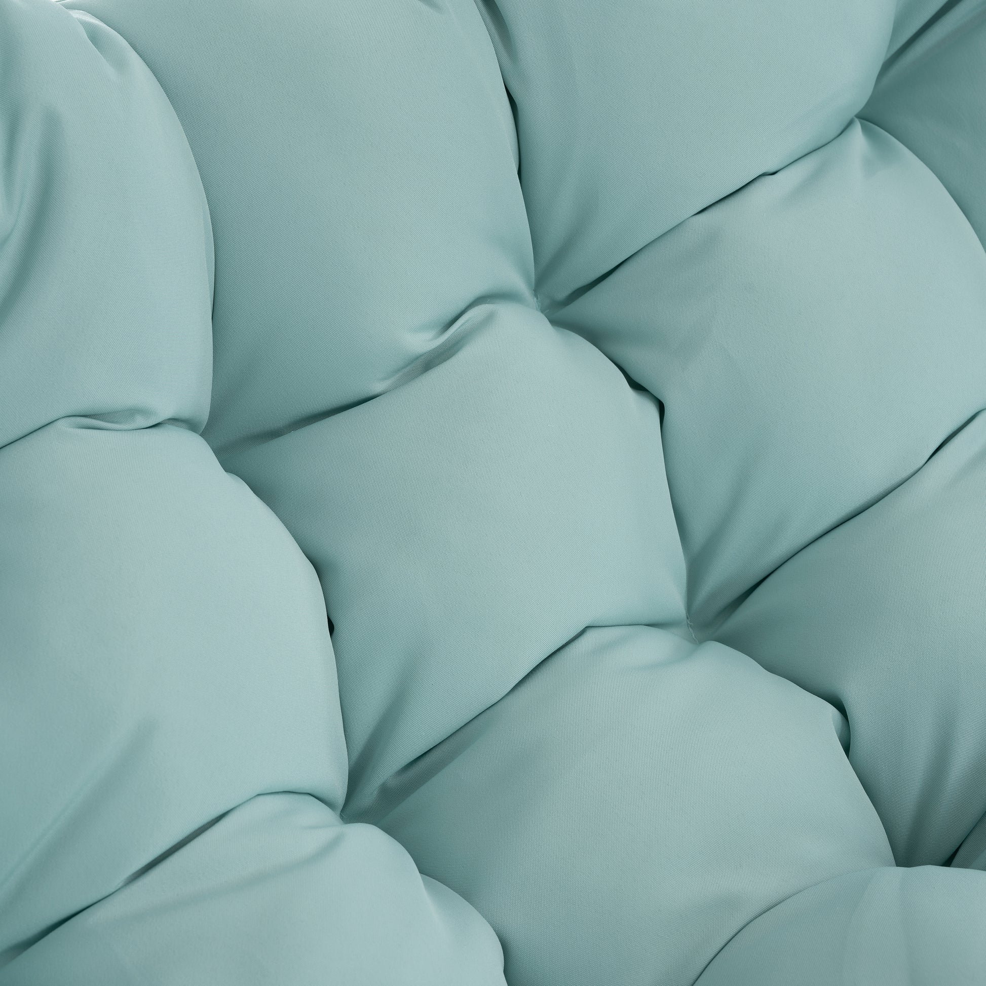 Closeup of plush light blue fabric with diamond tufting detail on a comfortable cushion