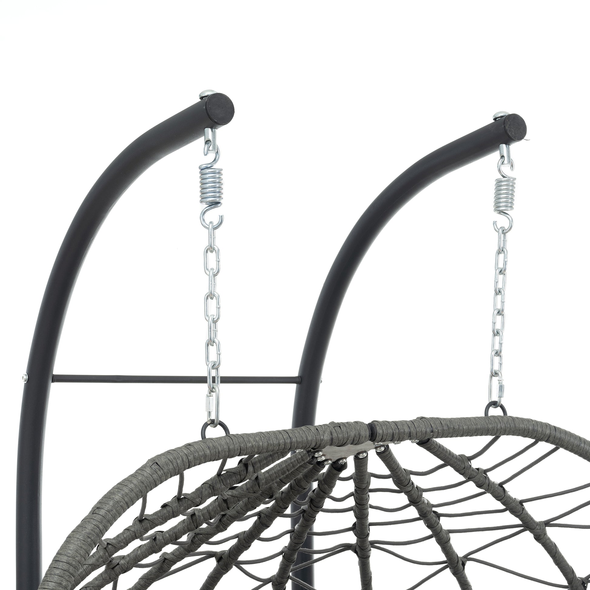 Closeup of a grey rattan egg chair with a metal stand and chain suspension system
