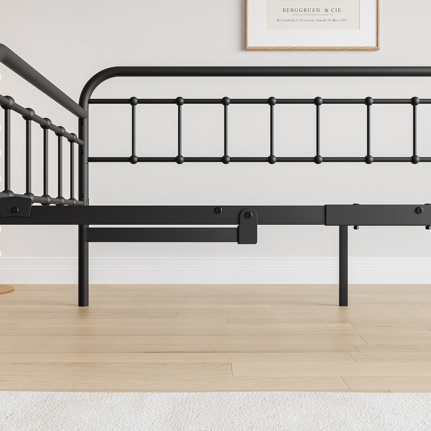 Black metal bed frame with decorative finial posts and a slatted headboard design