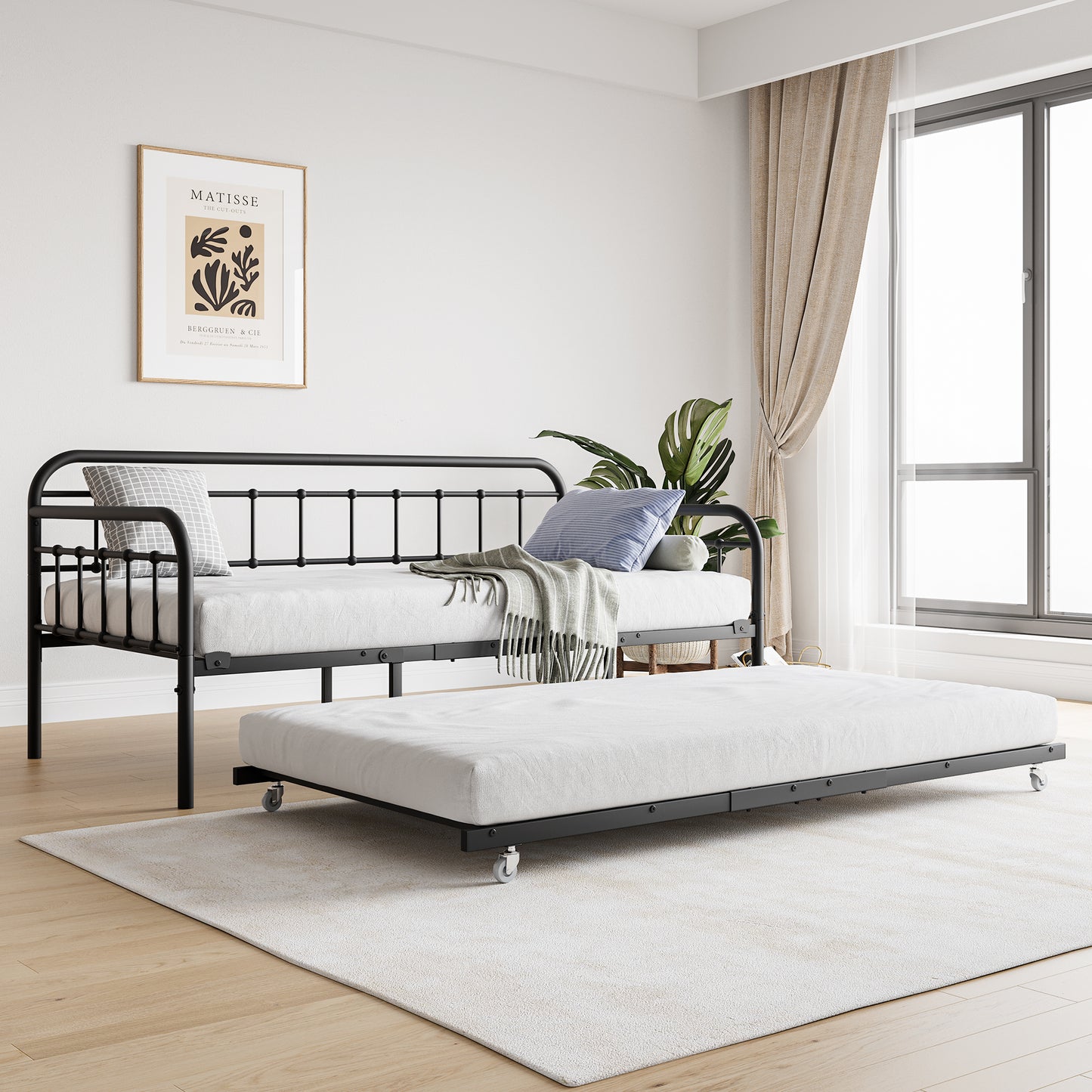 Black metal daybed with pullout trundle and white mattresses ideal for guest rooms