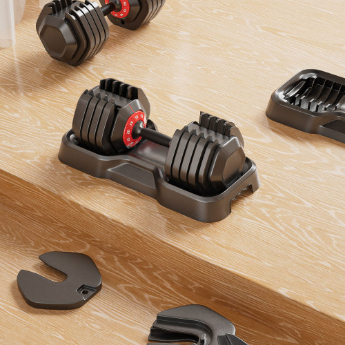 Adjustable dumbbell set with red weight markers on a wooden surface ideal for home gyms