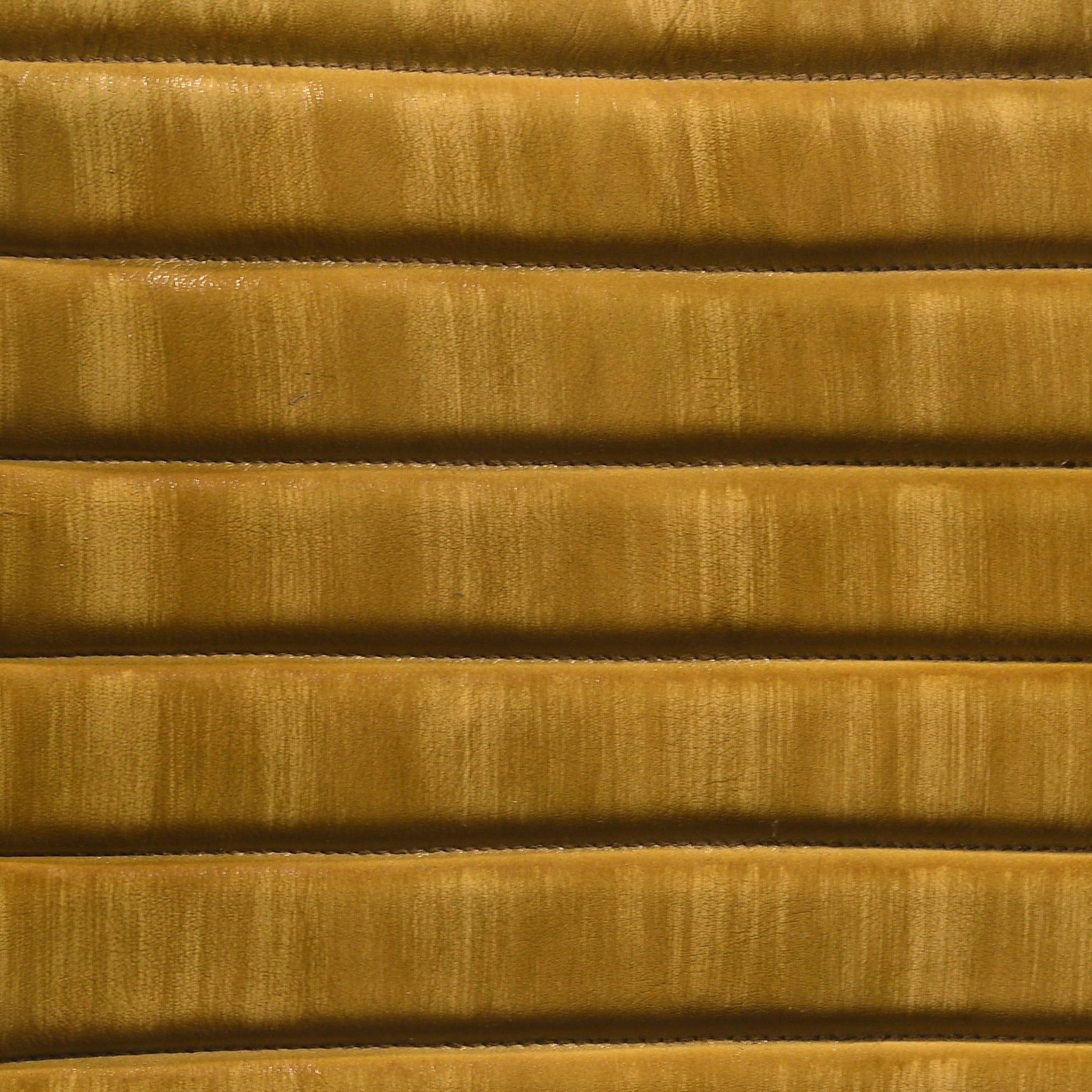 Textured mustard yellow velvet fabric with horizontal channel tufting detail