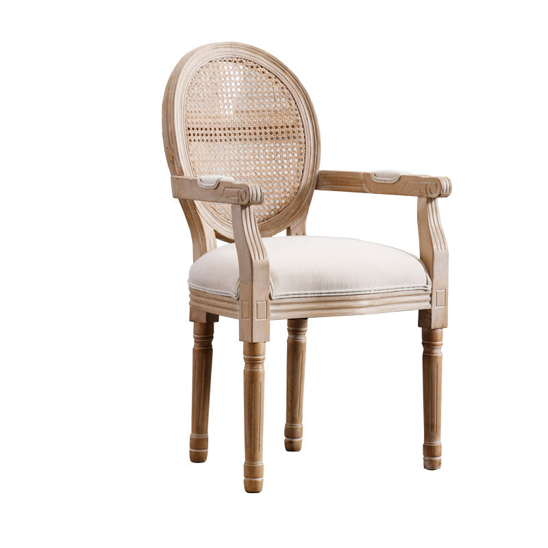 French provincial armchair with distressed wood frame and natural cane back
