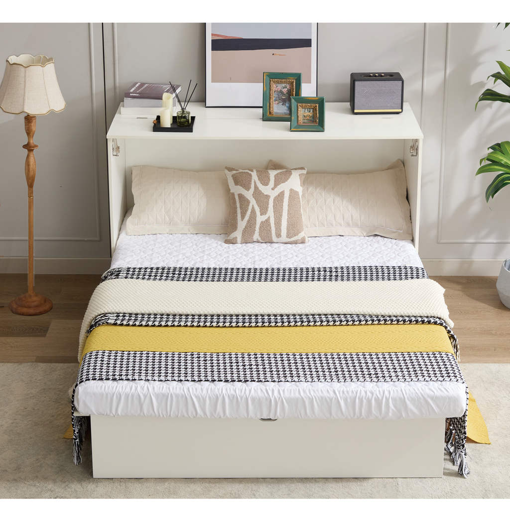 White murphy bed with layered blankets and pillows