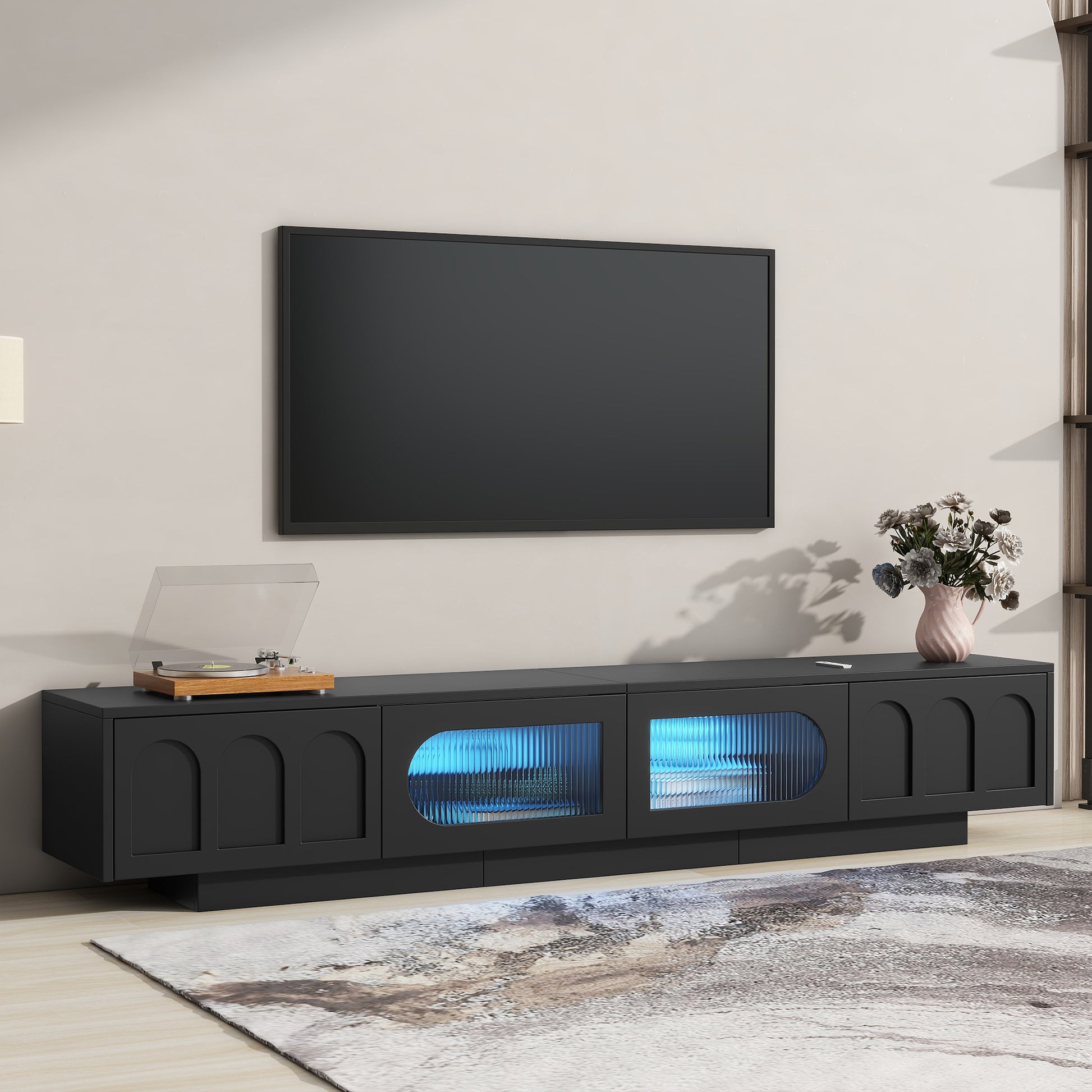Modern black media console with textured glass doors and blue LED lighting