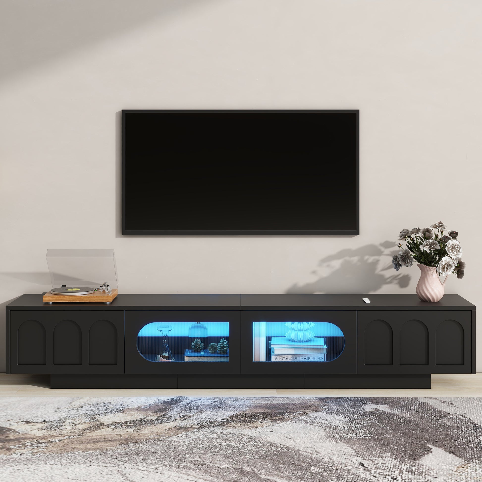 Black modern media console with arched cabinet doors and blue LED lighting