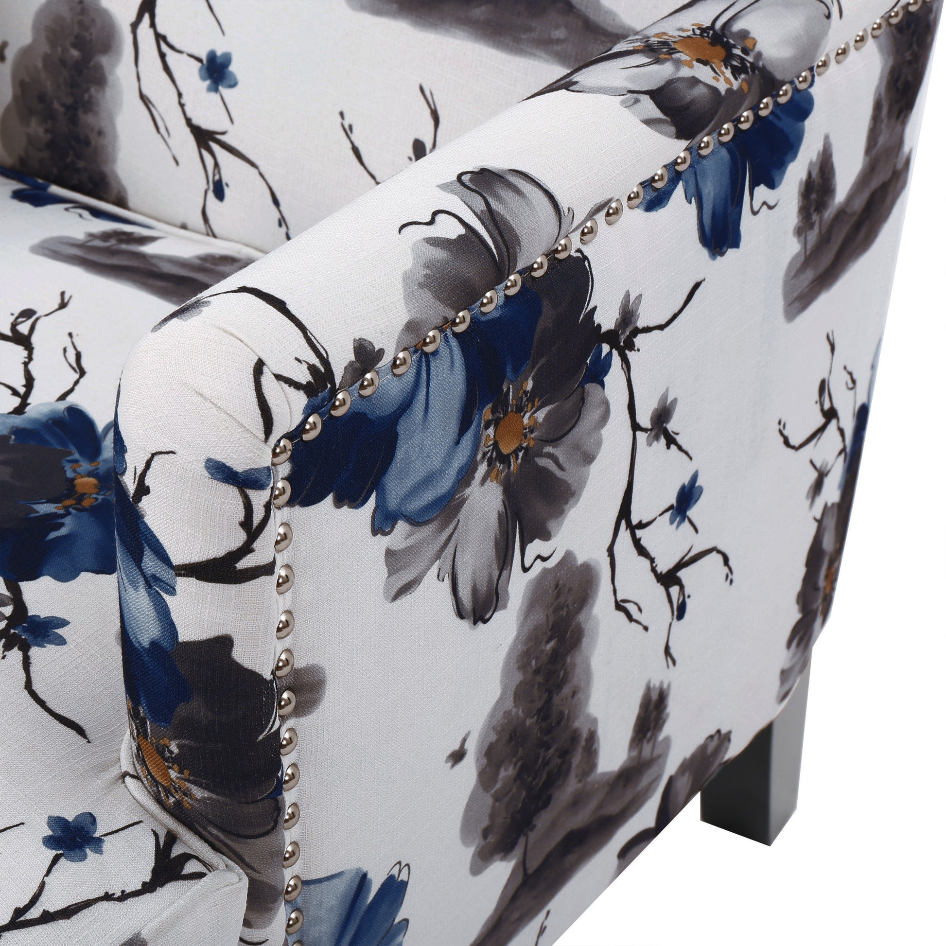 White armchair with navy blue floral print fabric and silver nailhead trim detail