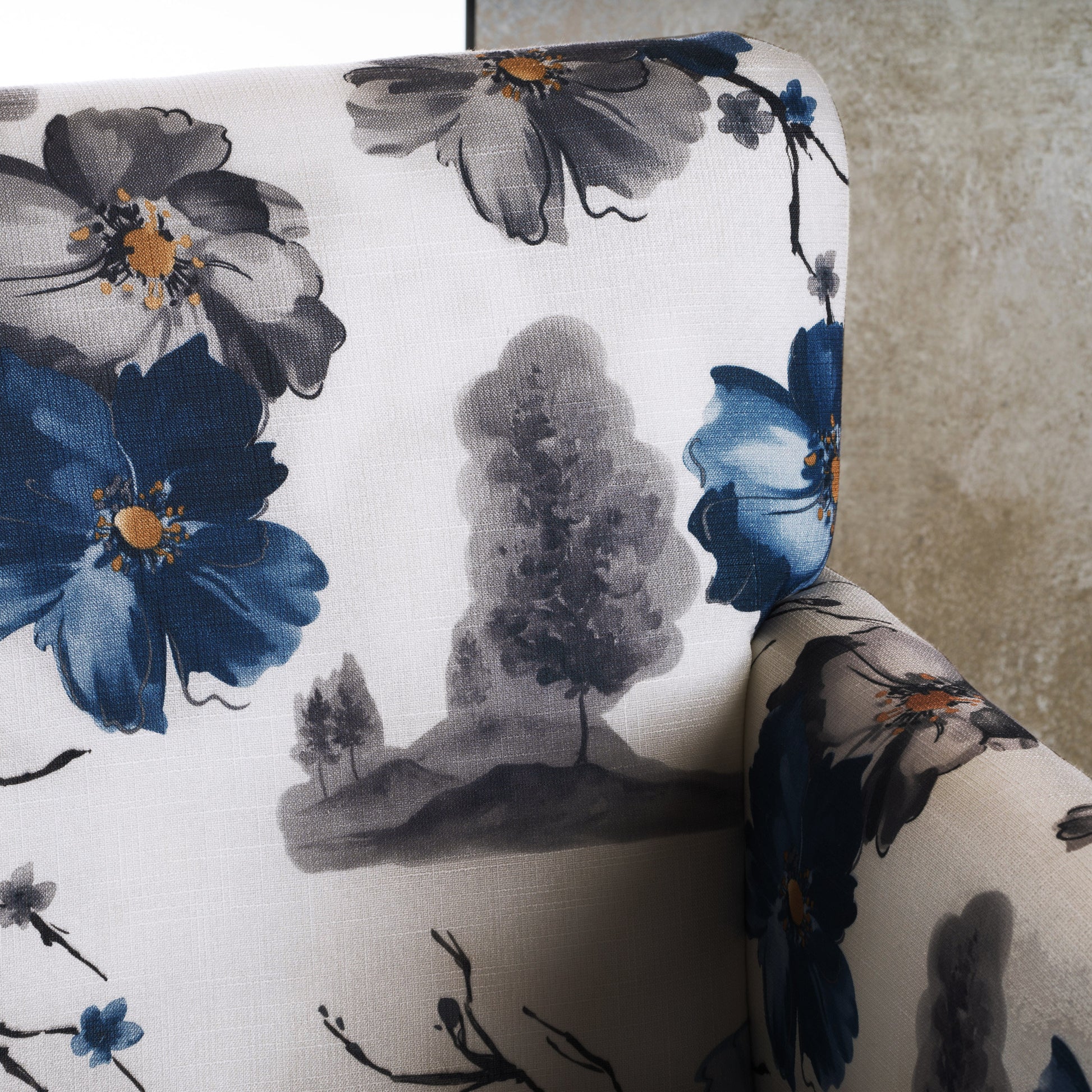 Cream fabric armchair with large blue and grey floral print accentuating a tranquil aesthetic