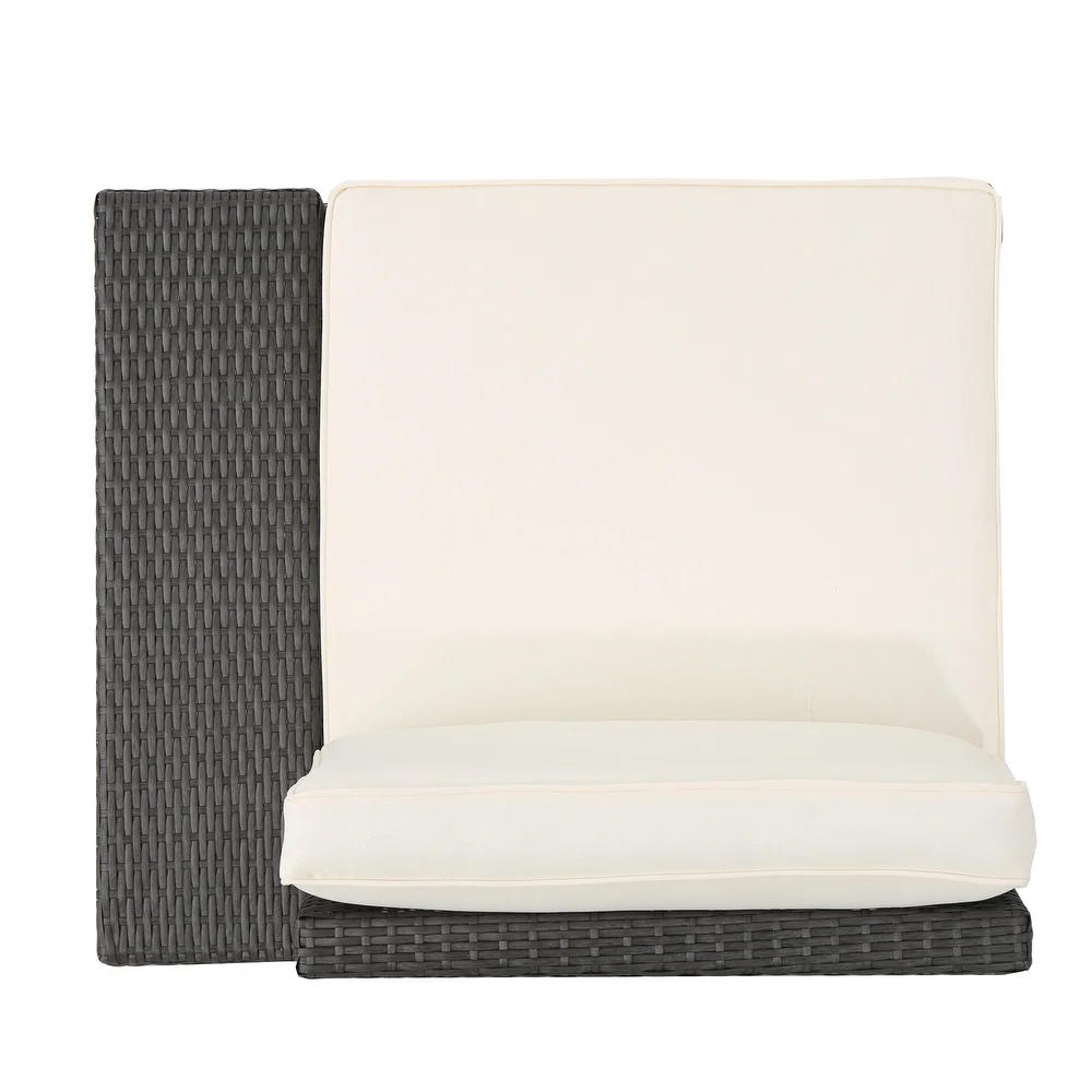 Top view of a dark gray wicker outdoor chair with a cream cushion