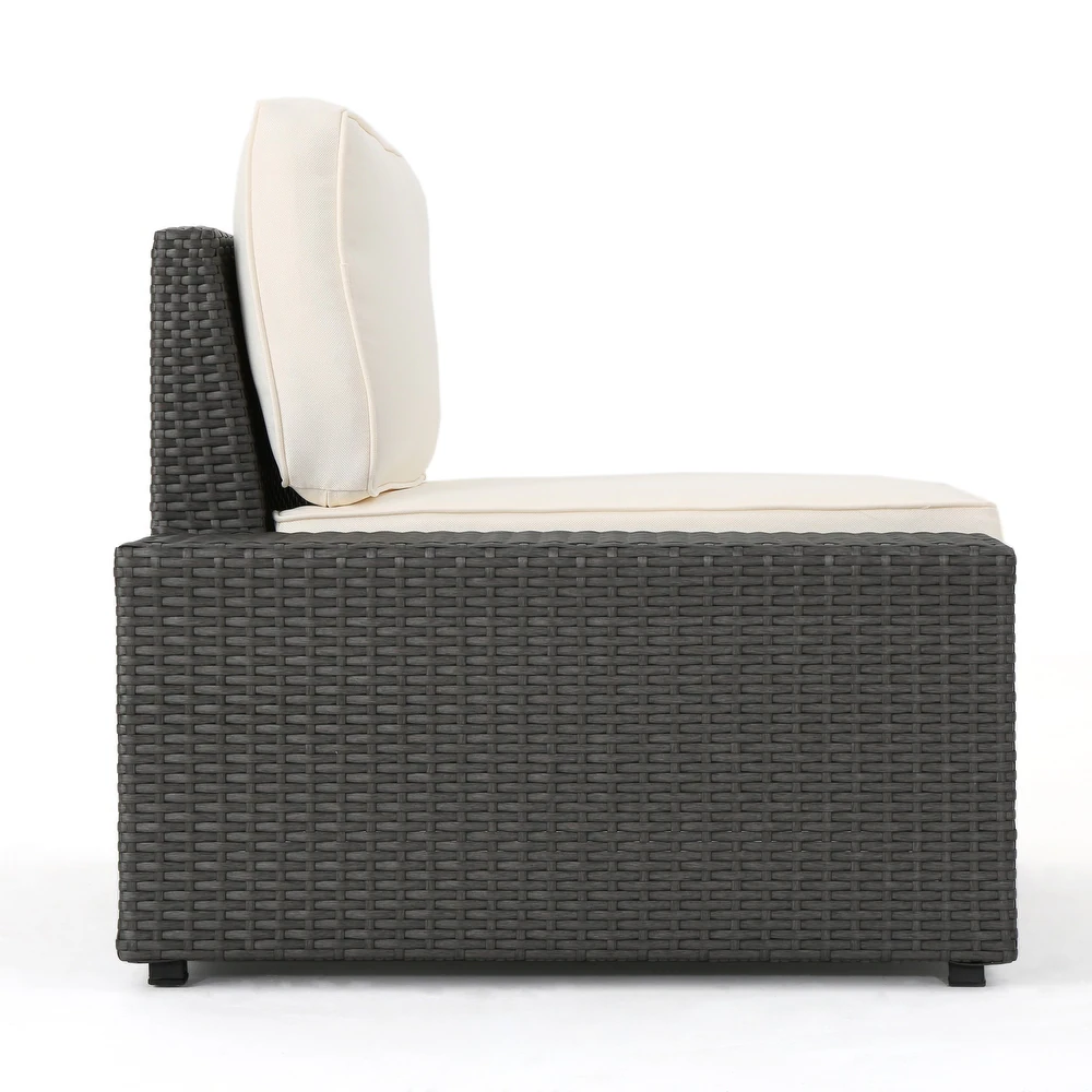 Dark gray wicker patio chair section with cream cushions