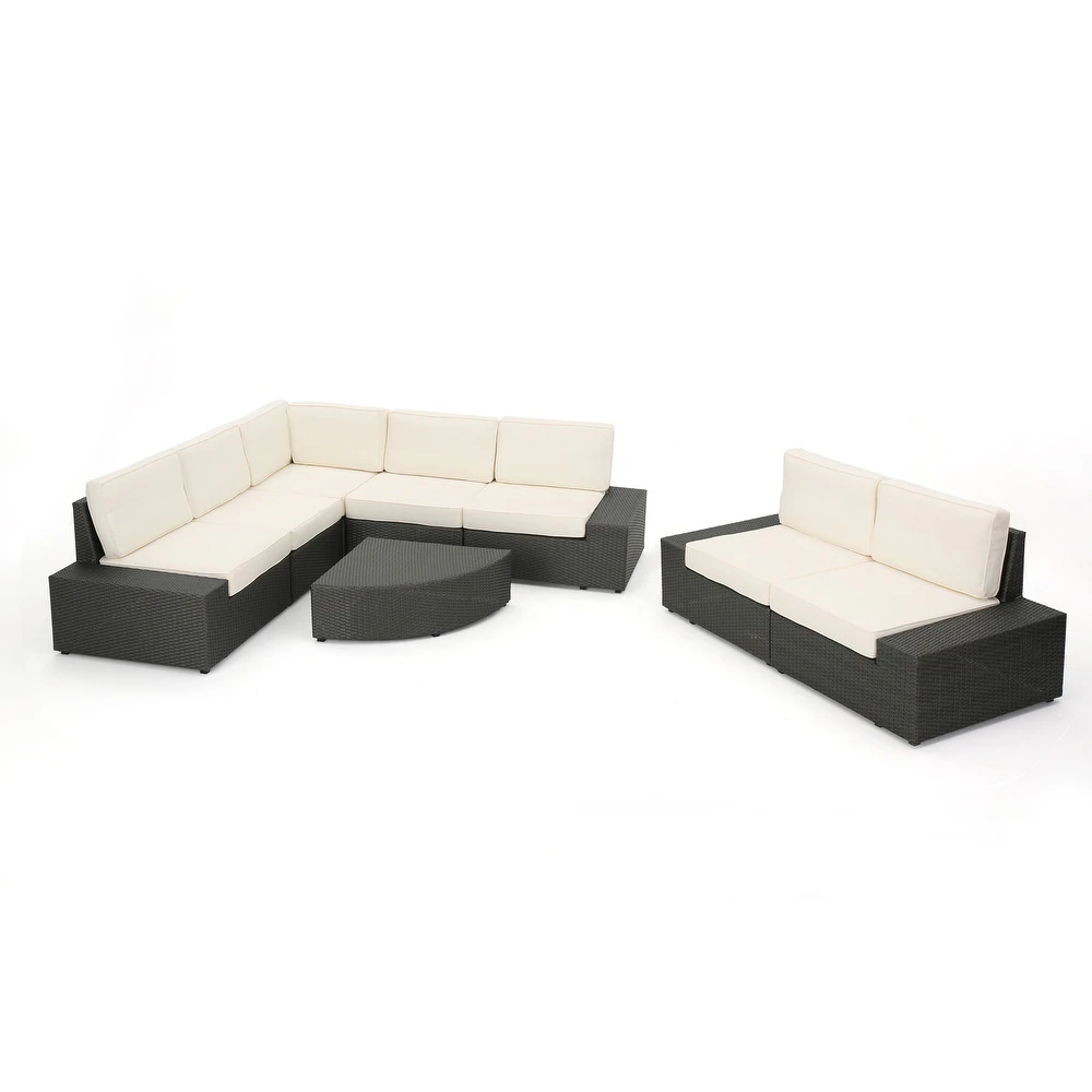 Dark grey wicker sectional outdoor furniture with cream cushions
