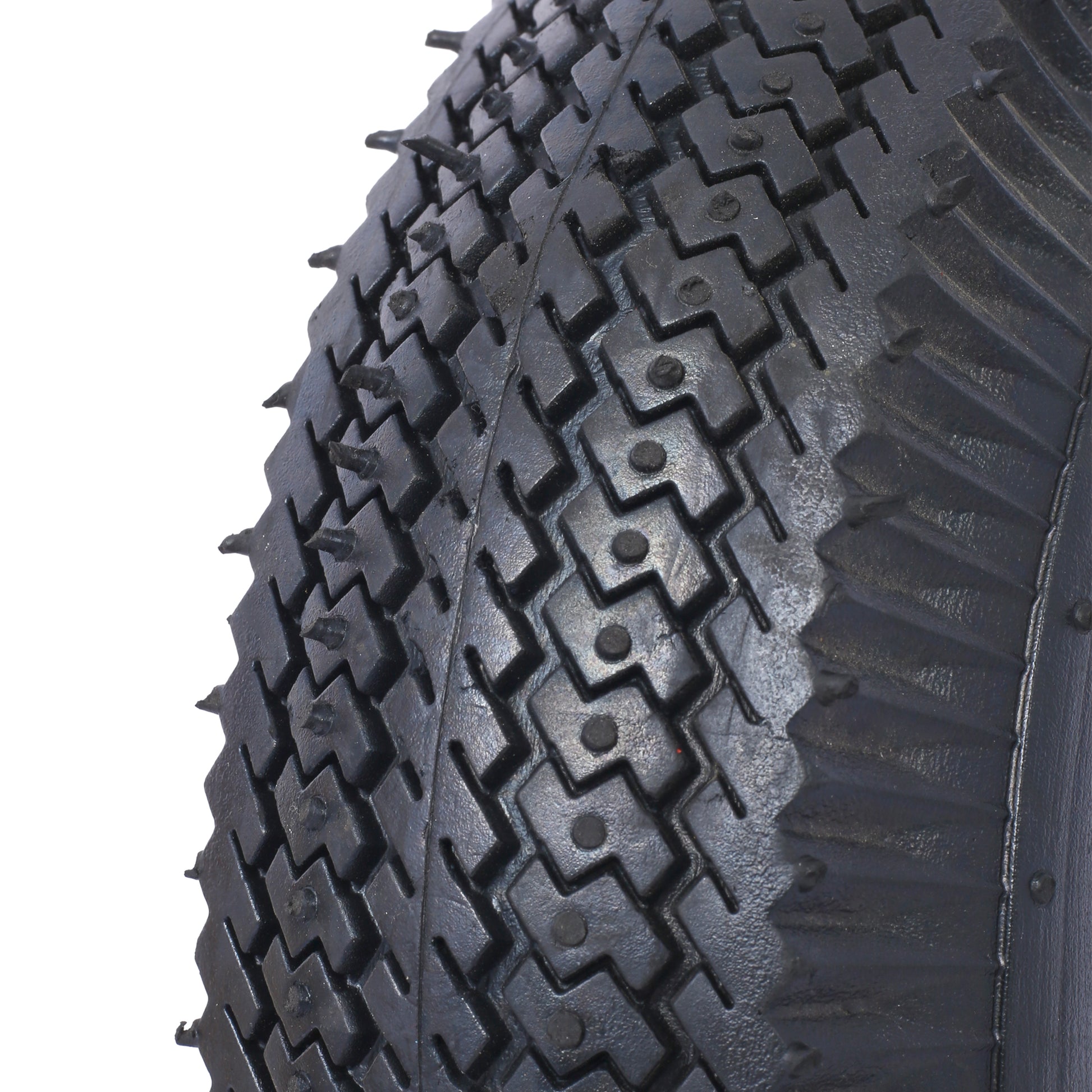 Closeup of a heavyduty black tire tread with integrated metal studs for traction