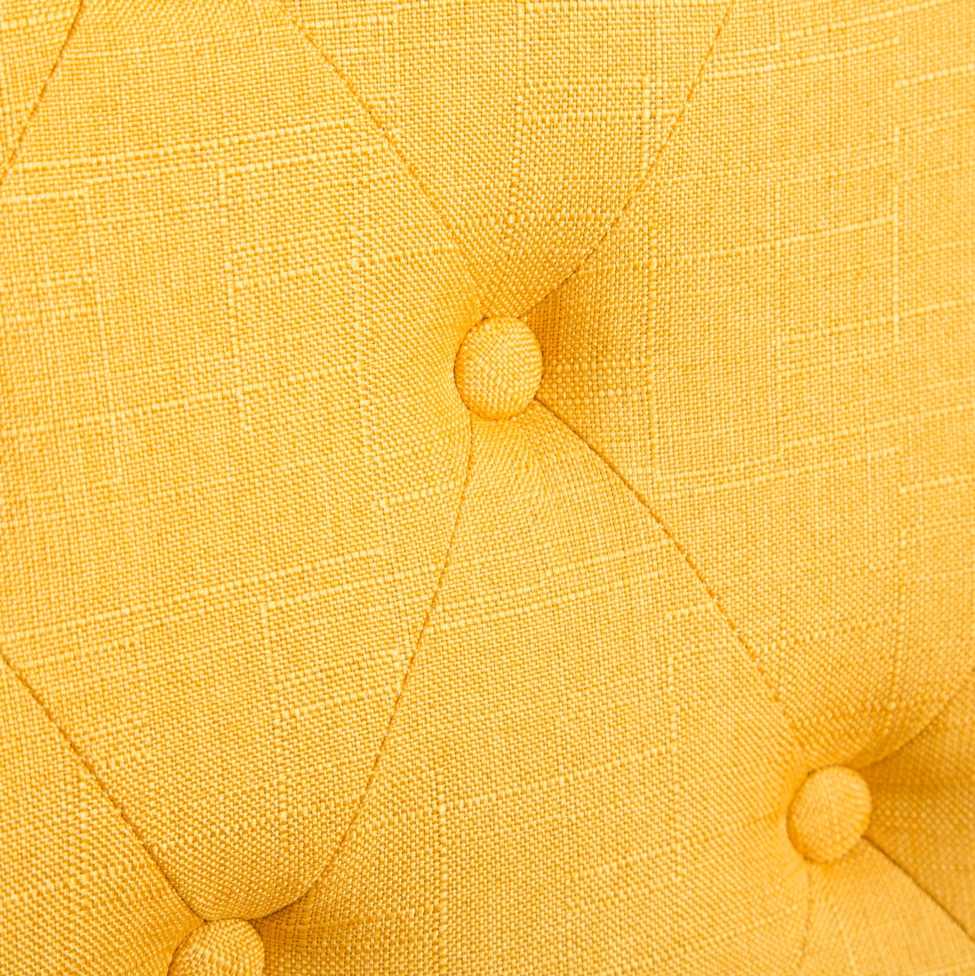 Closeup of bright yellow textured fabric with diamond tufting and buttons for upholstery