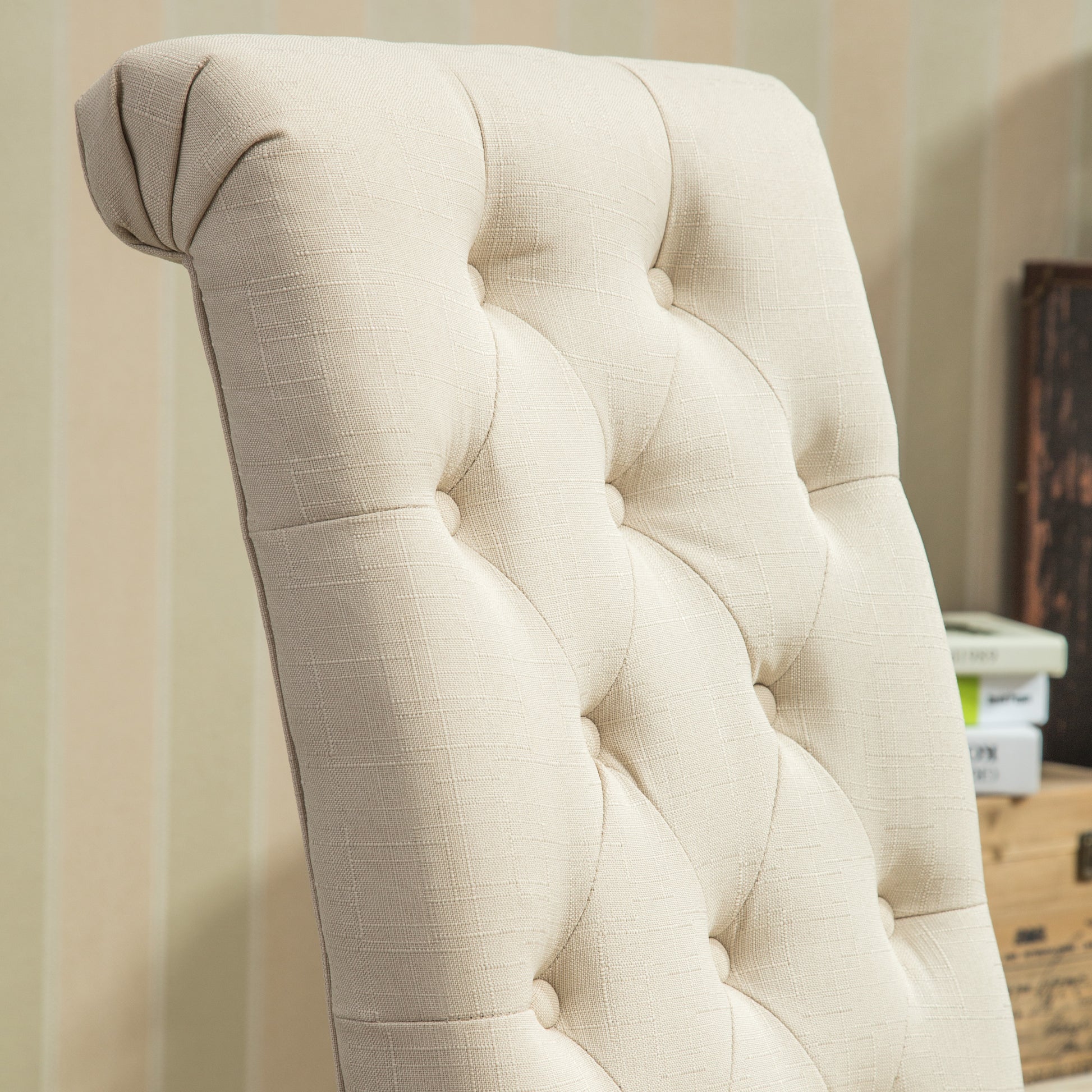 Cream upholstered dining chair with tufted backrest and subtle texture