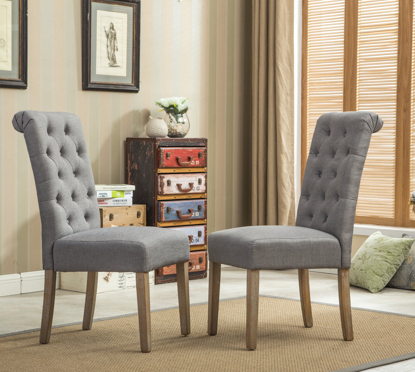 Two grey tufted dining chairs with wooden legs for a classic dining room