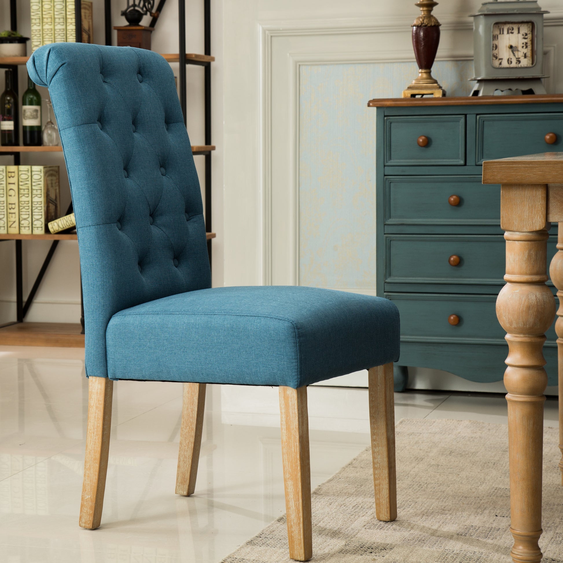 Tufted blue fabric dining chair with light wood legs elegant scroll back and button tufting