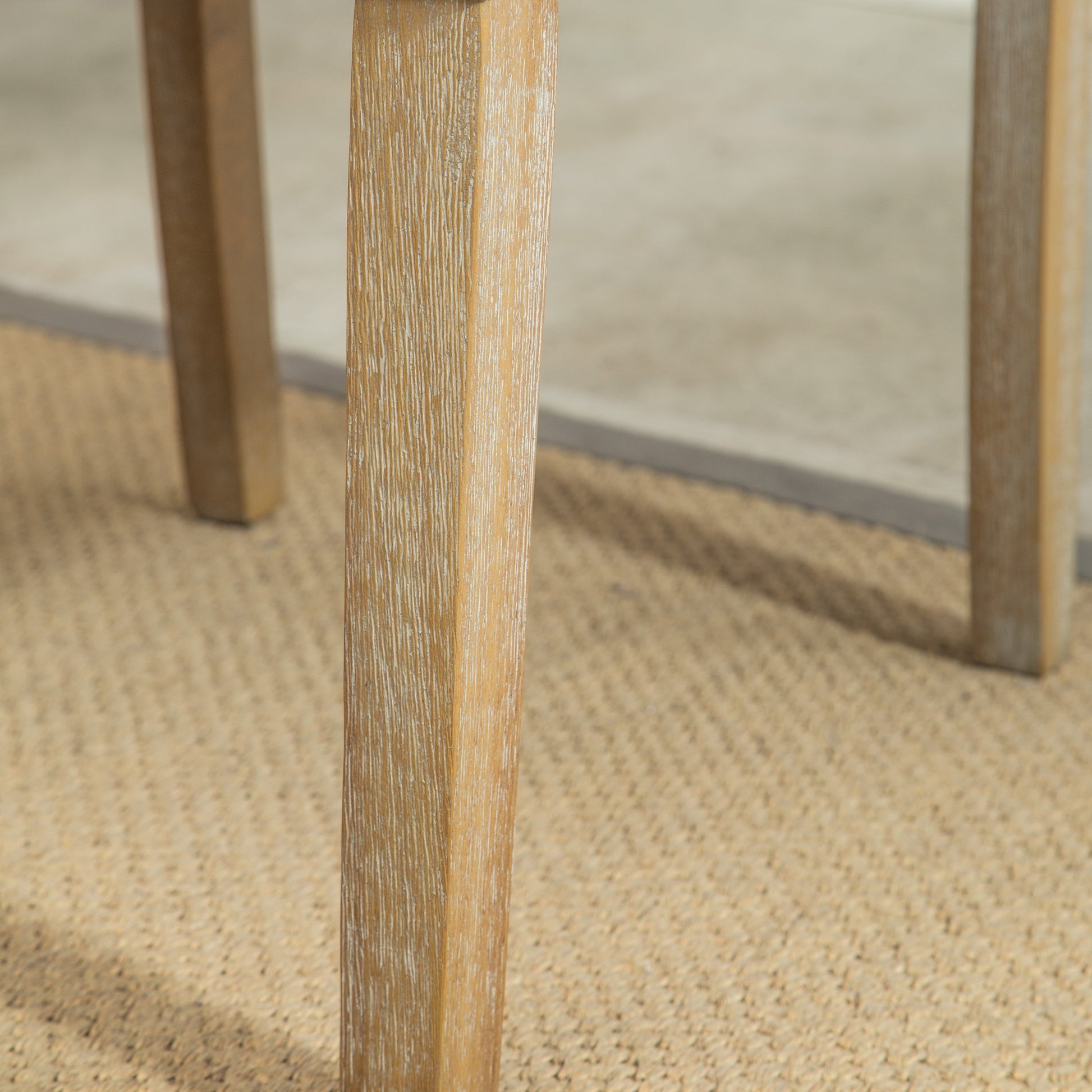 Closeup of a light oak wood table leg with a distressed finish perfect for rustic dining rooms