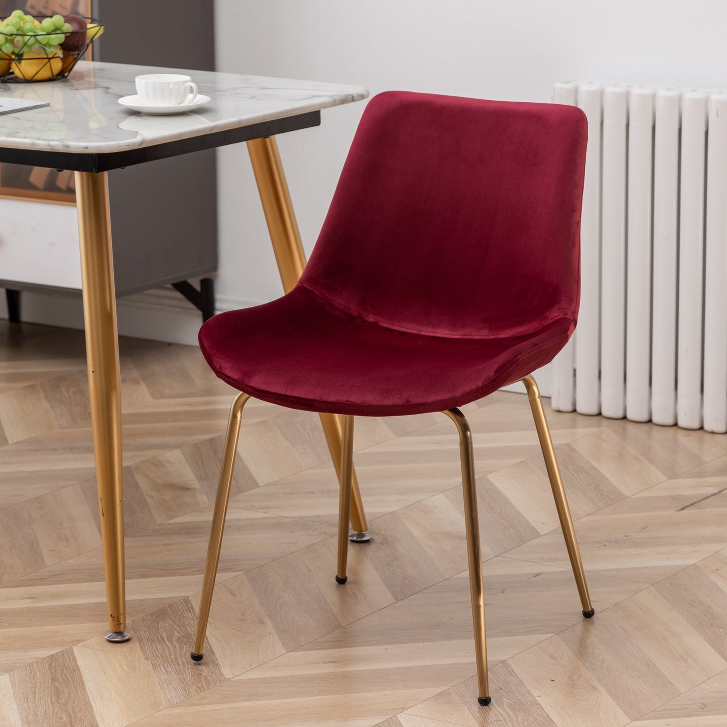 Plush burgundy velvet dining chair with sleek gold metal legs for a modern look